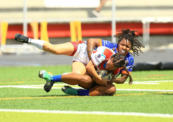 womens rugby player tackling